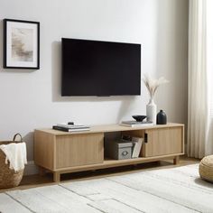 a flat screen tv mounted to the side of a wooden entertainment center in a living room