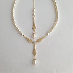 the necklace is adorned with pearls and diamonds