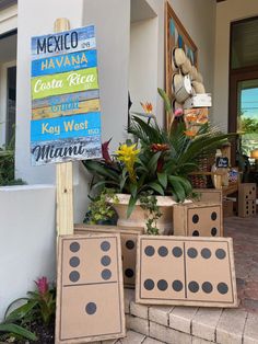 some cardboard boxes are sitting on the ground near a sign that says mexico, havana and costa rica