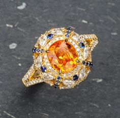 * Condition: Brand new * Center Stone: Natural Spessartite Fanta Garnet, Oval Brilliant cut, Approx 2.29ct * Side stones:  Natural White Diamond, Round-cut, Marquise cut (VVS clarity with F color) Natural Blue Sapphire, Round-cut * Two in one jewelry, can use on ring or pendant. * Metal Purity: 18k Solid Yellow Gold (optional) * Chain Length: 45cm (adjustable) * Free DHL Express Shipping. * Attached with Certificate.  * Each piece is made-to-order with care and special attention to detail.  all Luxury Yellow Gold Garnet Diamond Ring, Elegant Multi-stone Yellow Sapphire Jewelry, Elegant Yellow Sapphire Multi-stone Jewelry, Luxury Orange Jewelry With Yellow Sapphire, Luxury Orange Yellow Sapphire Jewelry, Luxury Yellow Sapphire Jewelry, Orange Round Yellow Sapphire Jewelry, Orange Round Jewelry With Brilliant Cut, Luxury Orange Jewelry With Gemstone Accents