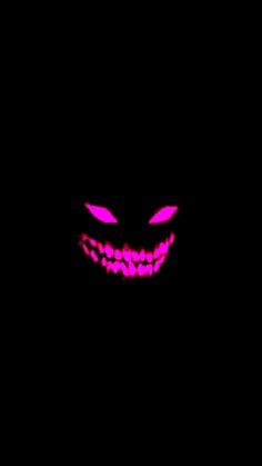 an evil looking face in the dark with glowing pink lights on it's eyes