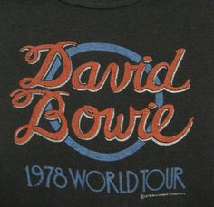 the words david bovie are painted in orange and blue on a black t - shirt