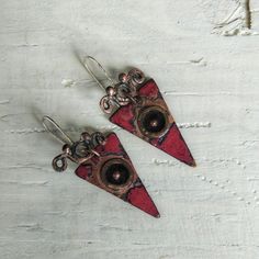 These exquisite earrings are a blend of modern and vintage aesthetics, hence the name "Now and Then." The bold triangle shape adds a contemporary touch, while the red enamel brings a vibrant pop of color. The black enamel circle with the copper dot represents a timeless focal point, symbolizing the connection between past and present Unique Handmade Triangle Earrings, Unique Triangle Earrings As A Gift, Vintage Aesthetics, Modern Earrings, Triangle Shape, Now And Then, Black Enamel, Handmade Accessories, Past And Present