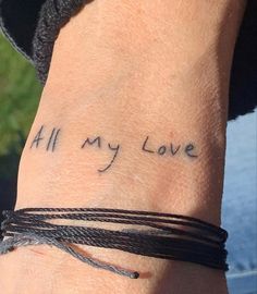 a woman's wrist with the words all my love written on her left arm