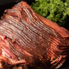 a large piece of meat sitting on top of a black plate