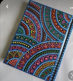 an intricately painted notebook on a white surface