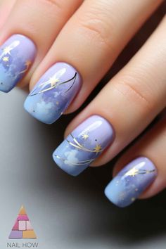 Let your nails mimic the night sky with these enchanting light purple nails, displaying a gradient effect with golden stars. These purple nails ideas are ideal for a dreamy night out. For more magical designs, head over to nailhow.com! Nail Designs Blue And Purple, Purple And Blue Nail Art, Purple New Years Nails, Night Sky Nail Designs, Nail Ideas Night Sky, Purple Nails With Moon And Stars, Purple Star Nail Designs, Purple Blue Nails, Blue Purple Nails