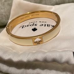 Kate Spade Bangle Bracelet. Cream And Gold. Kate Spade Gold Bangle, Kate Spade Bracelet Stack, Kate Spade Bangle Bracelet, Luxury White Jewelry For Fashion Accessory, Cream Bangle Jewelry For Wedding, Cream Bangle For Wedding, Kate Spade Gold Bracelets, Chic Gold Kate Spade Bracelets, Chic Kate Spade Gold Bracelets