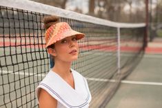 The Clementine in red is made for the lighthearted, the colorful, and the happy. She's useful just as much as she is stylish. This straw visor keeps the sun out of your eyes on the beach, playing tennis, or lounging by the pool. The Panama straw is woven from natural toquilla straw grown in Ecuador and woven by a single weaver each time, which takes several hours to complete. The straw is then shipped to the US and blocked in the US. The tie closure is made with ribbon. Playful Summer Visor Hat, Summer Red Visor Hats, Playful Red Summer Hat, Red Visor Hats For Summer, Fun Summer Visor Sun Hat, Adjustable Summer Tennis Hat, Adjustable Tennis Hats For Summer, Casual Summer Tennis Hat, Straw Visor