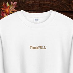 It's ThankFULL season! Thanksgiving, crewneck sweatshirt,  with high quality embroidered lettering. Perfect for Thanksgiving, Friendsgiving or anytime you want to look cute while you fill:) A pre-shrunk, classic fit sweater that's made with air-jet spun yarn for a soft feel and reduced pilling. * 50% cotton, 50% polyester * Pre-shrunk * Classic fit * 1x1 athletic rib knit collar with spandex * Air-jet spun yarn with a soft feel and reduced pilling * Double-needle stitched collar, shoulders, armholes, cuffs, and hem Thanksgiving Crewneck, Embroidered Hoodie, Fall Sweatshirt, Fall Design, Fitted Sweater, Rib Knit, Sweat Shirt, Thanksgiving, Crew Neck Sweatshirt