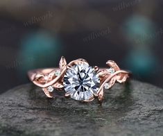 a rose gold ring with a diamond in the center on top of a stone surface