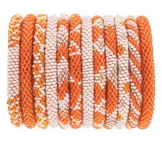 PERFECT FOR YOUR GAME DAY NEEDS! - The Original Roll-On® Bracelet in orange and white is perfect for back to school and football season! - Approximately 7” round -Ethically Crafted by our women artisans in Nepal -High quality glass beads and hand-dyed cotton thread -Expands over your hand to fit most wrists Aid Through Trade is a Founding Member of the Fair Trade Federation and is the only authorized provider of Fair Trade Roll-On® Bracelets Candle Workshop, Glam Jewelry, Scout Bags, Capri Blue, Women Artisans, Roll On, Hair Accessories Headbands, Orange White, Best Games