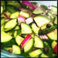 cucumbers and other vegetables are mixed together in a bowl