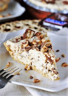 a piece of pie sitting on top of a white plate with a fork next to it