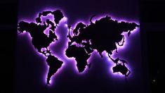 the world map is lit up with purple lights