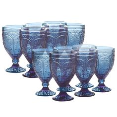 six blue glass goblets sitting next to each other