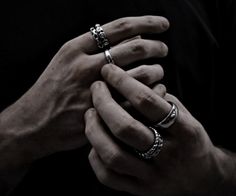 two hands holding each other with rings on their fingers