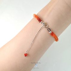 This handmade bracelet blazes with the fiery glow of Mexican fire opal. Vibrant orange beads in varying shades graduate from light to dark, creating an ombre effect that's as eye-catching as it is stylish. The smooth tyre-shaped fire opal gemstones at AAA grade bring a natural beauty to complement your everyday wardrobe. A 925 sterling silver adjustable chain ensures a perfect, comfortable fit. Fire opal's shimmering play of color adds a touch of magic to any ensemble, while handmade craftsmansh Orange Carnelian Round Beaded Bracelets, Orange Faceted Beads Bracelet As Gift, Orange Round Carnelian Beaded Bracelets, Orange Carnelian Beaded Bracelets, Orange Sterling Silver Jewelry With Round Beads, Handmade Orange Carnelian Beaded Bracelets, Orange Bracelet Jewelry With Lobster Clasp, Orange Bracelet With Lobster Clasp, Adjustable Orange Beaded Bracelet With Lobster Clasp