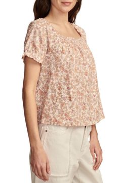 A cascading pattern of earthy flowers enlivens this all-cotton peasant top cut in a lightweight, flowy silhouette with smocked detail at the front and back. Square neck Short sleeves 100% cotton Machine wash, tumble dry Imported Flowy Smocked Bodice Peasant Top For Spring, Flowy Smocked Casual Tops, Casual Boho Print Rayon Tops, Casual Rayon Tops With Boho Print, Casual Flowy Smocked Top, Casual Smock Top Flowy Fit, Casual Flowy Smock Top, Cottagecore Cotton Blouse With Floral Print, Feminine Cotton Peasant Top For Spring