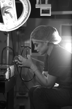 a black and white photo of a woman with a stethoscope in her hand