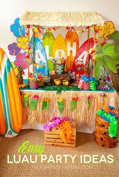 a surfboard themed birthday party with tropical decorations and luau decorating on the table