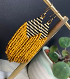 Pretty and bold beaded earrings!  A striped top with light cream and black beads nestles next to a waterfall of mustard seed beads  The mustard beads give beautiful movement and life to this fun pair All beads are Miyuki brand - known for their quality and durability. They are also lightweight, keeping this pair light and easy to wear Hooks are locally sourced and are gold plated nickel free  Earrings measure 3" from top of hook to bottom bead Every pair of earrings are hand made by me with love Affordable Yellow Beaded Earrings For Summer, Earrings Fall, Handmade Earrings Beaded, Nickel Free Earrings, Fall Earrings, Free Earrings, Gold Moon, Skull Earrings, Silver Moon