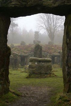 a stone structure in the middle of a field