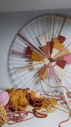 an old spinning wheel with yarn and crochet on it