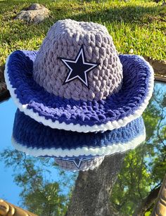 a crocheted hat sitting on top of a puddle