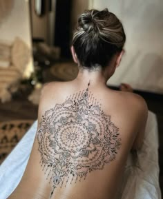 a woman with a tattoo on her back