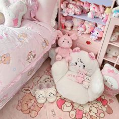 a pink bedroom with teddy bears and other stuffed animals on the floor next to a bed