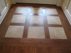 a wooden floor with white and brown squares on the top, in an empty room