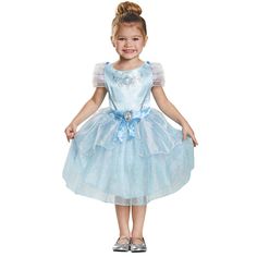 Your little princess will enchant the whole court in her Cinderella Halloween costume. This elegant dress has a glittering stagecoach design with a blue ribbon waist featuring a gold framed cameo of Cinderella. The sparkling tea-length skirt in powder blue is the perfect princess attire. Watch her twirl the night away as she goes in search of some Halloween magic! Her fairy godmother couldn't have created a lovelier gown. This Cinderella dress is a perfect fairytale costume for girls. Toddler Cinderella Costume, Disney Kızları, Cinderella Dress Costume, Cinderella Halloween Costume, Cinderella Dress Disney, Classic Halloween Costumes, Blue Satin Dress, Cinderella Dress, Disney With A Toddler