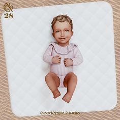 a baby doll sitting on top of a wooden floor next to a white mouse pad