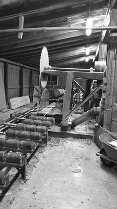 an old black and white photo of machinery in a warehouse with lots of wood planks