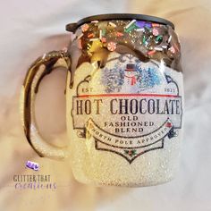 a frosted glass coffee mug with the words hot chocolate and sprinkles on it