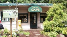 there is a store called carver cafe on the side of the road in front of some trees