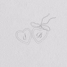 two hearts with the letter s on them are drawn in pencil and placed next to each other