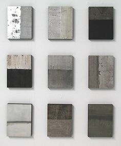 nine square and rectangle metal pieces on a white wall