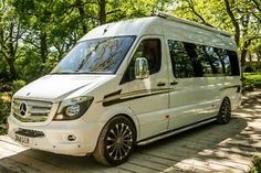 a white van parked on top of a wooden platform