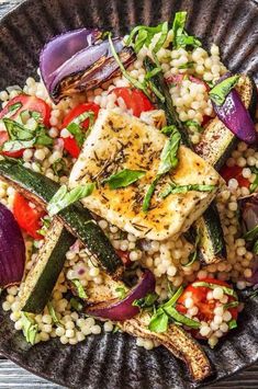 grilled tofu with vegetables and couscous in a bowl