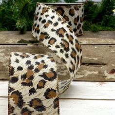 a pair of leopard print ribbon sitting on top of a wooden table