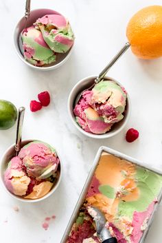 three bowls filled with ice cream next to an orange and lime