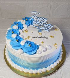 a blue and white birthday cake on a table