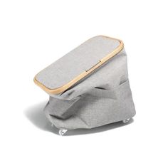 the back side of a gray bag with wheels on it and a wooden handle that is attached