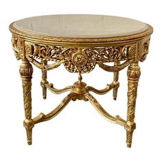 This center table is the perfect piece to add glitz, glam and luxury to an entryway. The gold finish on this piece is beautifully paired with a beige marble top that adds the perfect touch of elegance.   This table features an intricate floral beauty of baroque carvings and delicate curved legs.  Dimension: 31.5"H x 42.5" Diameter. Table Gogogne, Coffee Table Wedding, Antique Coffee Table, Fancy Furniture, Candy Pastel, Deco Baroque, French Baroque, Marble Round Coffee Table, Fancy Table