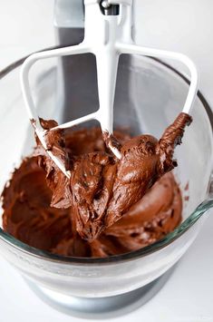 a mixer with chocolate frosting in it