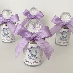 three glass jars with purple bows and elephants on them