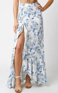 This delightful skirt boasts a stunning design that's perfect for warm weather. The off white background is playfully scattered with bold, blue flowers that flow throughout the dress. As you move, the cascading ruffles along the bottom trim of the... Floral Print Maxi Skirt, Ruffle Maxi Skirt, Floral Print Design, Floral Maxi Skirt, Printed Maxi Skirts, Floral Print Maxi, Beautiful Skirts, Blue Skirt, Floral Maxi