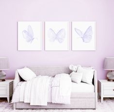 a bedroom with two paintings on the wall and a bed in the foreground,